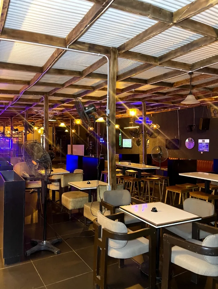 The full lounge terrace under the wooden beams