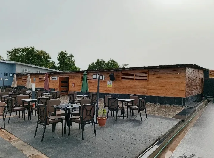 Terrace tables and umbrellas outside the timber-clad room