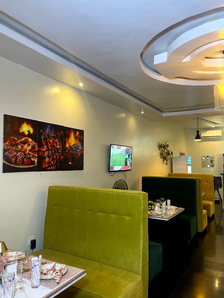Lime and green banquettes beneath the grill artwork